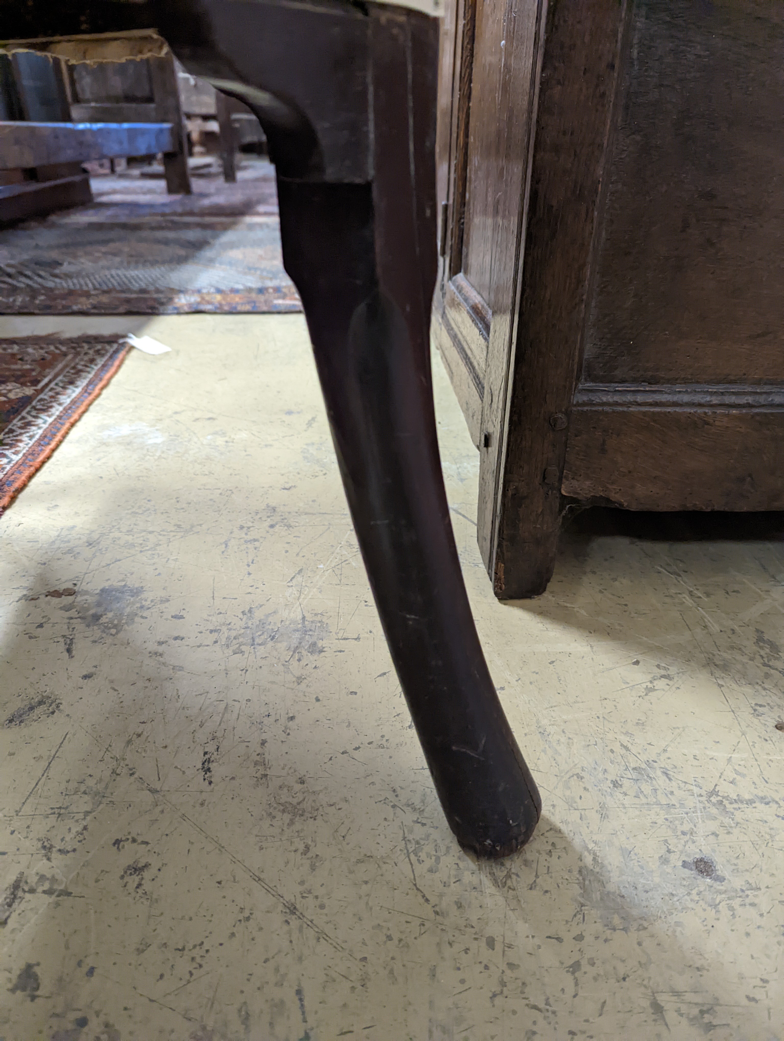 A George II mahogany wingback armchair, with slender cabriole legs and pad feet, width 80cm, depth 66cm, height 126cm